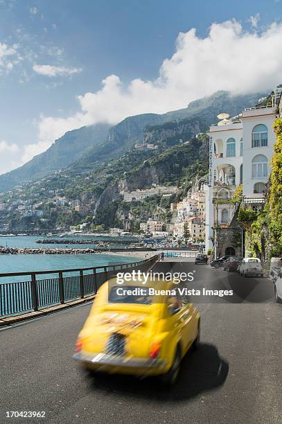 little italian car (fiat 500) on the amalfi coast - amalfi fotografías e imágenes de stock