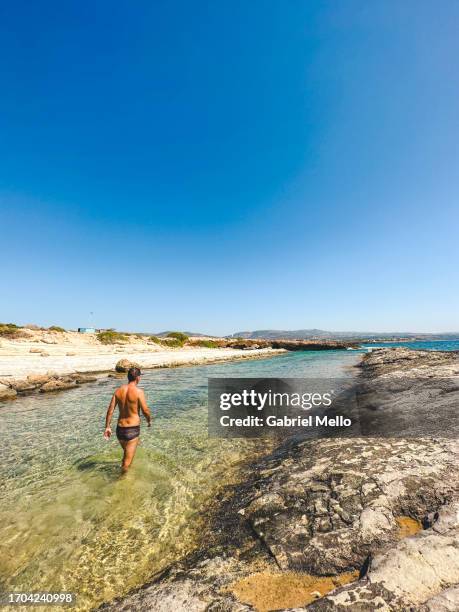 man standing by the water in paphos - paphos stockfoto's en -beelden