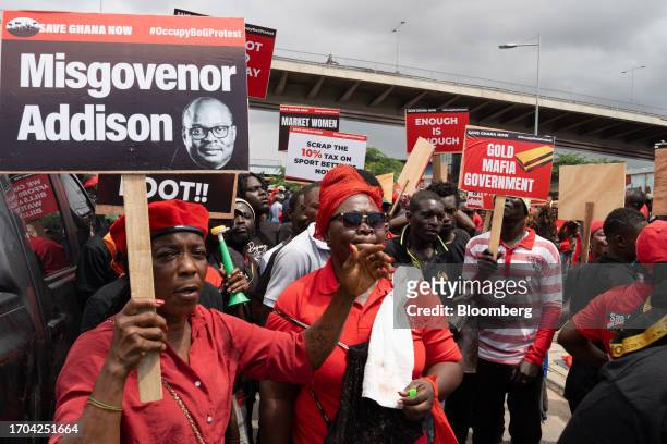 Demonstrator holds a placard featuring Ernest Addison, governor of Ghana's central bank, during the 'Occupy Bank of Ghana' protest in Accra, Ghana,...