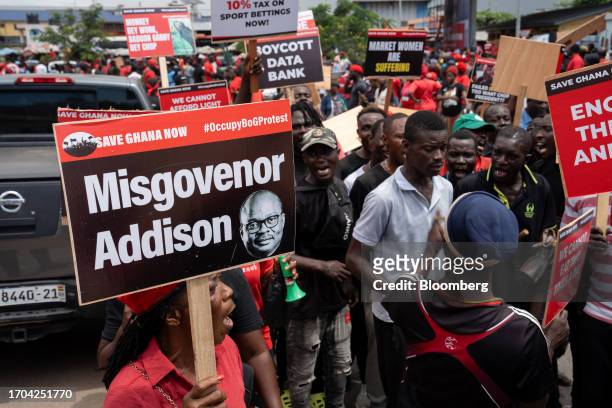 Demonstrator holds a placard featuring Ernest Addison, governor of Ghana's central bank, during the 'Occupy Bank of Ghana' protest in Accra, Ghana,...