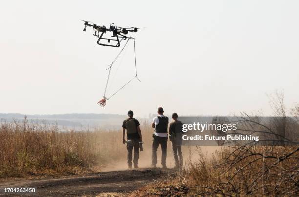 Representatives of the Postup NGO inspect a mined area with a drone as part of demining works, Kharkiv Region, north-eastern Ukraine.