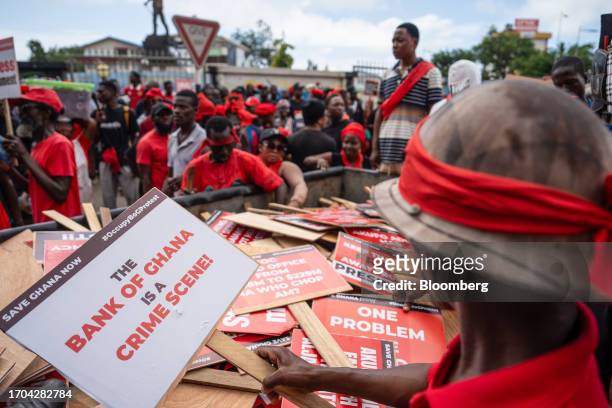 Demonstrators collect placards during the 'Occupy Bank of Ghana' protest in Accra, Ghana, on Tuesday, Oct. 3, 2023. The demonstration is the latest...