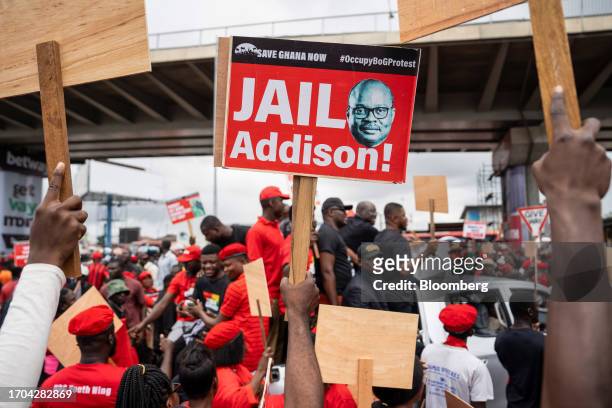 Demonstrator holds a placard featuring an image of Ernest Addison, governor of Ghana's central bank, during the 'Occupy Bank of Ghana' protest in...