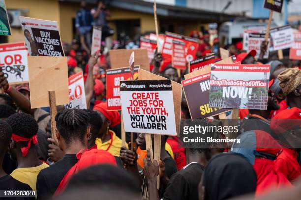 Demonstrators hold placards during the 'Occupy Bank of Ghana' protest in Accra, Ghana, on Tuesday, Oct. 3, 2023. The demonstration is the latest in...