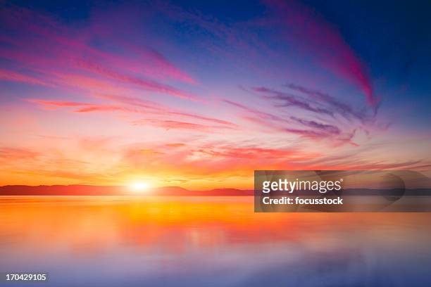 sunset over water - majestic clouds stock pictures, royalty-free photos & images