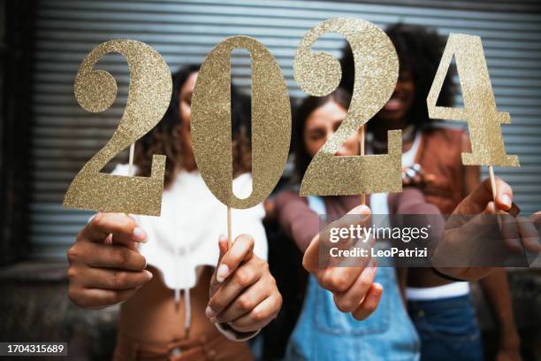 group of friends celebrating 2024 new year - 2024 stock pictures, royalty-free photos & images
