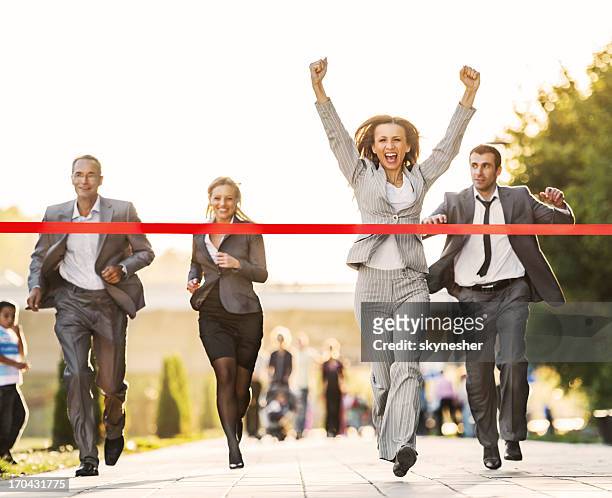 business people running to finish, crossing red line. - rivaliteit stockfoto's en -beelden