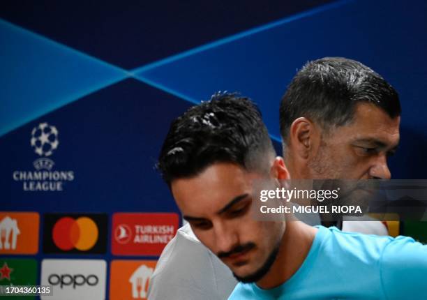Porto's Canadian midfielder Stephen Eustaquio and FC Porto's Portuguese coach Sergio Conceicao arrive to a press conference after a training session...