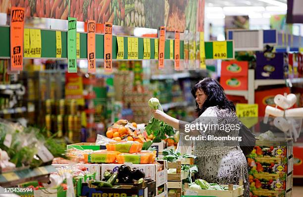 Customer browses fresh vegetables for sale inside a Lidl discount supermarket store, operated by Schwarz Group, in Prague, Czech Republic, on...