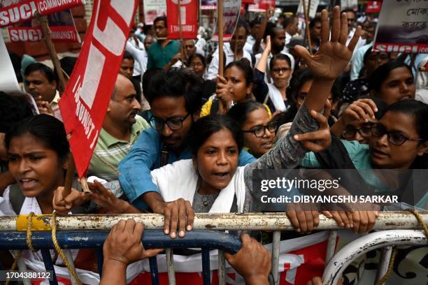 Activists and members of Social Unity Center of India shout slogans as they scuffle with police during a protest against the rise in dengue and other...