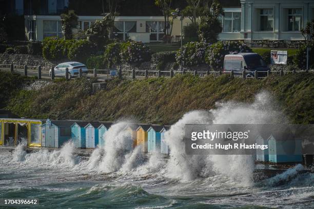Row of beach huts are swamped by waves at Castle Beach on September 27, 2023 in Falmouth, Cornwall, England.