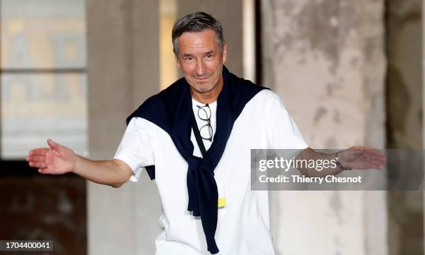 Dries Van Noten walks the runway at the end of the Dries Van Noten Womenswear Spring/Summer 2024 show as part of Paris Fashion Week on September 27,...