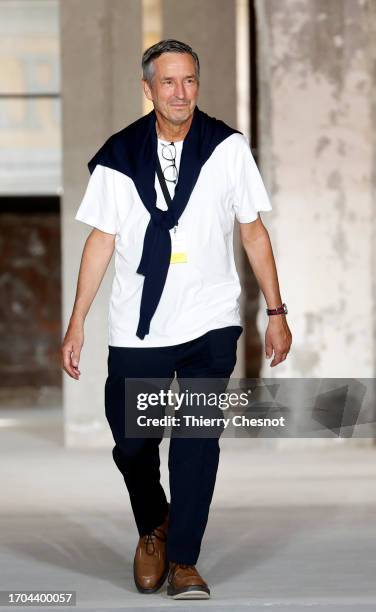 Dries Van Noten walks the runway at the end of the Dries Van Noten Womenswear Spring/Summer 2024 show as part of Paris Fashion Week on September 27,...