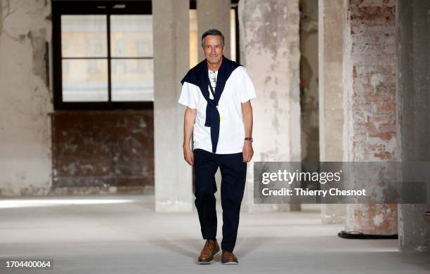 Dries Van Noten walks the runway at the end of the Dries Van Noten Womenswear Spring/Summer 2024 show as part of Paris Fashion Week on September 27,...