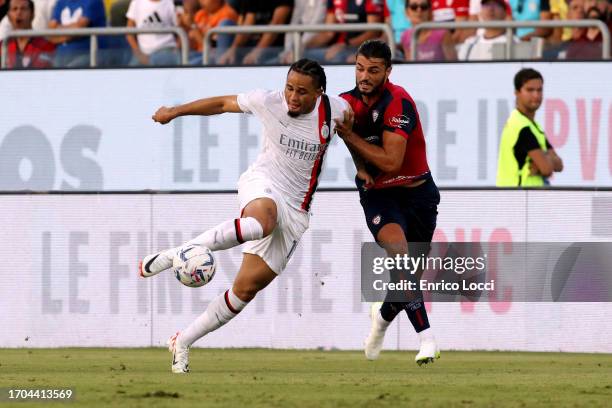 Alberto Dossena of Cagliari competes for the ball with Pantelis Hatzidiakos of AC Milan during the Serie A TIM match between Cagliari Calcio and AC...