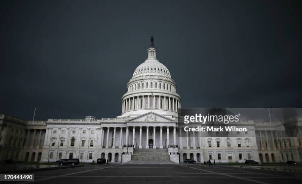 Storm clouds fill the sky over the U.S. Capitol Building, June 13, 2013 in Washington, DC. Potentially damaging storms are forecasted to hit parts of...