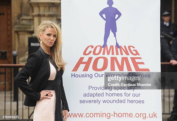 Sarah Harding poses as she makes a visit in her role as ambassador for the Coming Home charity at House of Commons on June 13, 2013 in London,...