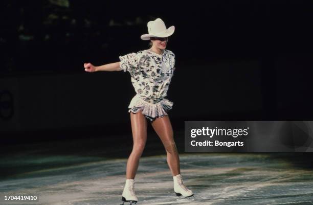 German figure skater Katarina Witt wearing a white cowboy hat as she performs her routine on the ice during the ladies' singles competition at the...