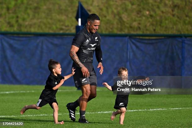 Aaron Smith of the All Blacks runs with his children Luka and Leo following a New Zealand All Blacks training session at LOU rugby club on September...