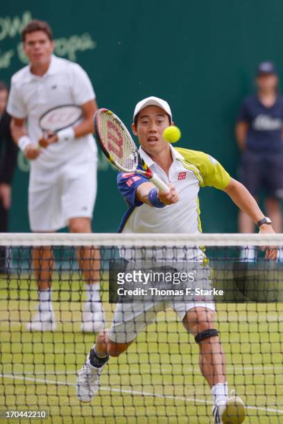Kei Nishikori of Japan plays a forehand in his doubles match with Milos Raonic of Canada against Philipp Kohlschreiber of Germany and Mikhail Youzhny...
