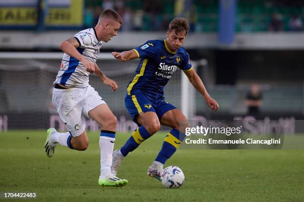 Filippo Terracciano of Hellas Verona FC competes for the ball with Emil Holm of Atalanta BC during the Serie A TIM match between Hellas Verona FC and...