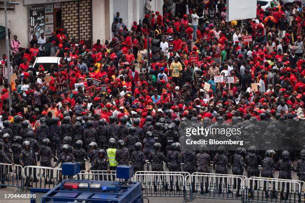 Police officers form a barricade in front of demonstrators during the 'Occupy Bank of Ghana' protest in Accra, Ghana, on Tuesday, Oct. 3, 2023. The...