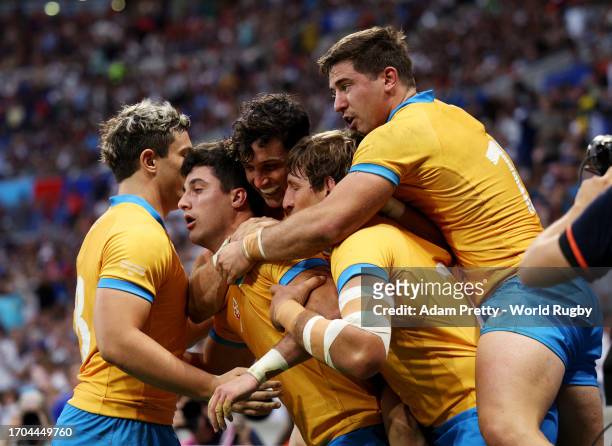 Bautista Basso of Uruguay celebrates with teammates after scoring his team's fifth try during the Rugby World Cup France 2023 match between Uruguay...