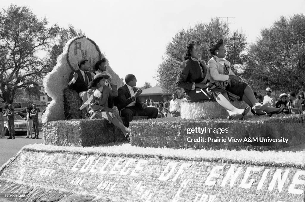 Miss Homecoming and participant sitting on cart during event