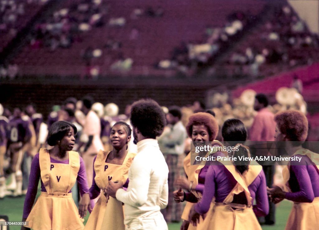 Cheerleaders conversing at event