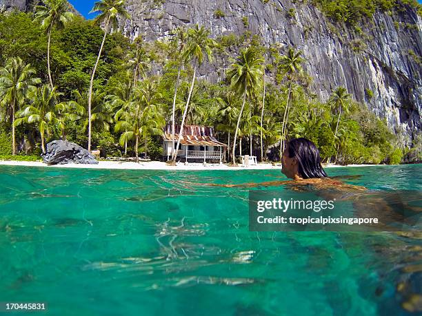 the philippines, palawan province, el nido, swimming in tropical waters. - palawan island stock pictures, royalty-free photos & images
