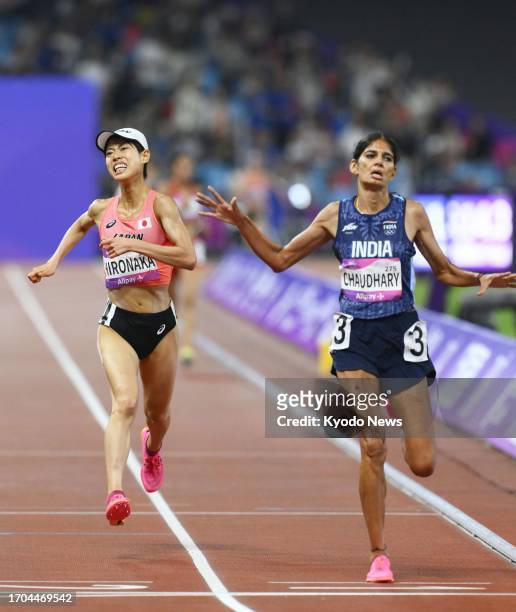 India's Parul Chaudhary and Japan's Ririka Hironaka compete en route to finishing first and second, respectively, in the women's 5,000-meter final at...