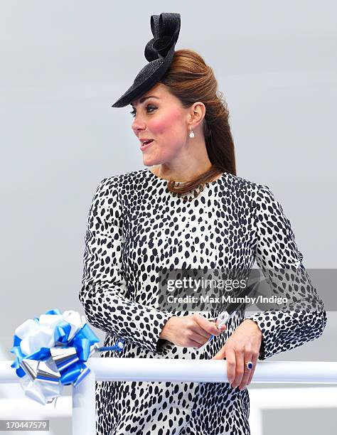 Catherine, Duchess of Cambridge cuts a rope to smash a bottle of Champagne on the hull of the new Princess Cruises ship 'Royal Princess' during the...