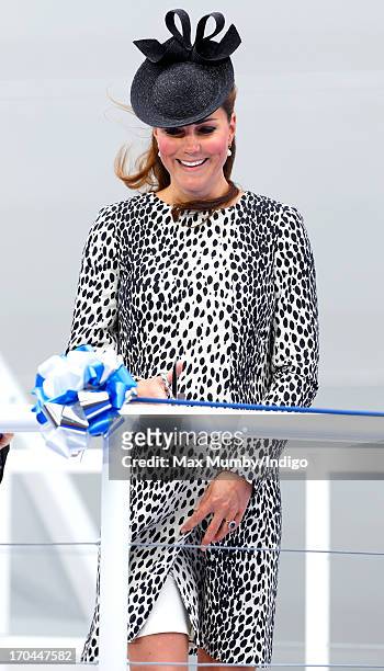 Catherine, Duchess of Cambridge cuts a rope to smash a bottle of Champagne on the hull of the new Princess Cruises ship 'Royal Princess' during the...