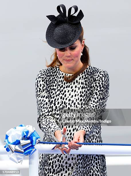 Catherine, Duchess of Cambridge cuts a rope to smash a bottle of Champagne on the hull of the new Princess Cruises ship 'Royal Princess' during the...
