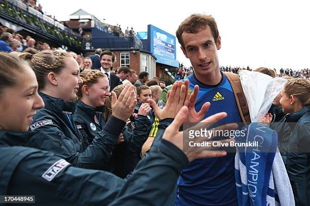 Andy Murray of Great Britain walks off the court past ballgirls after victory during the Men's Singles third round match against Marinko Matosevic of...