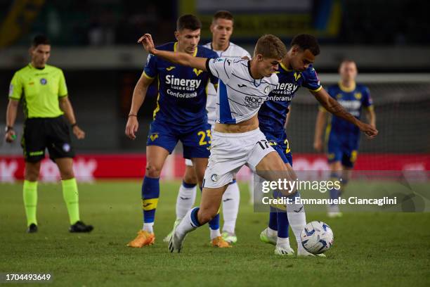 Charles De Ketelaere of Atalanta BC competes for the ball with Cyril Ngonge of Hellas Verona FC during the Serie A TIM match between Hellas Verona FC...