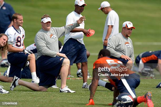 Chris Kuper and J.D. Walton of the Denver Broncos stretch during the last day of minicamp June 13, 2013 at Dove Valley.