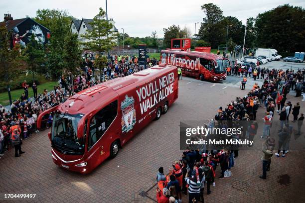 Spectators look on as the Liverpool team buses arrive at the stadium prior to the Carabao Cup Third Round match between Liverpool and Leicester City...