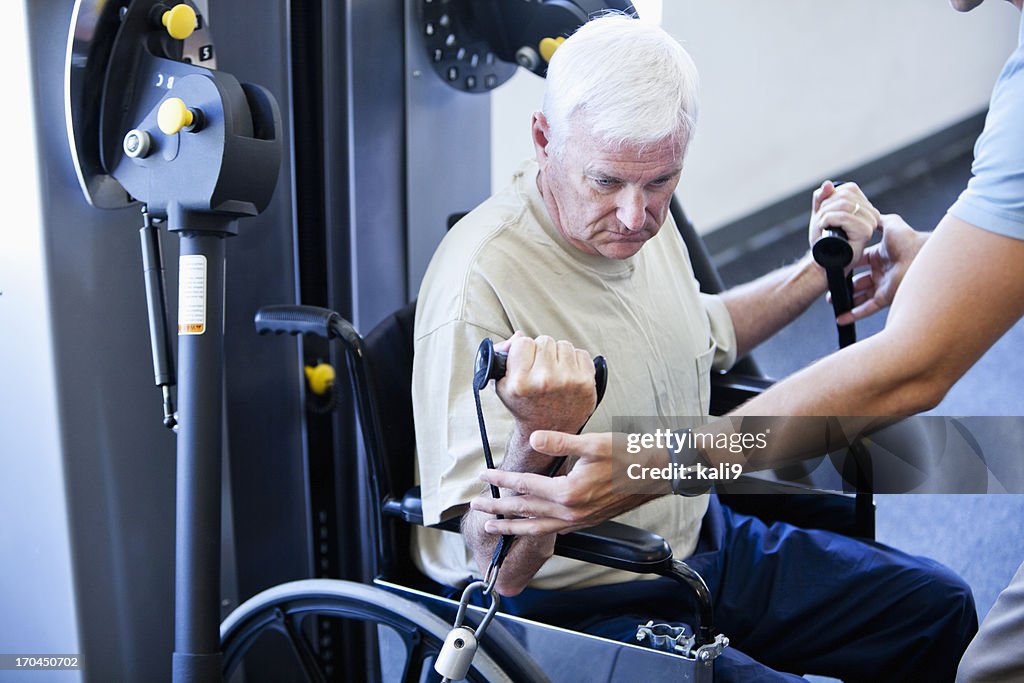 Man in wheelchair doing physical therapy exercises