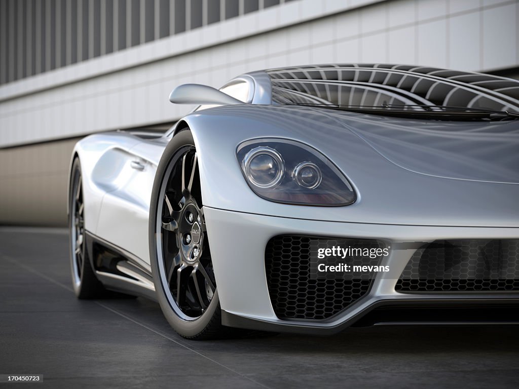 A silver sports car on black tile floor