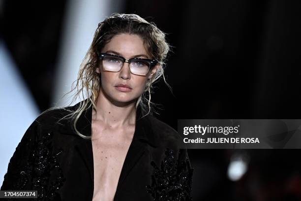 Model Gigi Hadid walks the runway with models to present creations by Miu Miu during the Paris Fashion Week Womenswear Spring/Summer 2024 in Paris on...