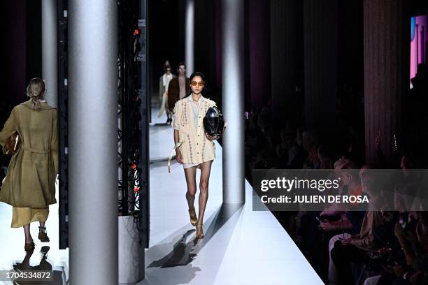 Models walk the runway to present a creation by Miu Miu during the Paris Fashion Week Womenswear Spring/Summer 2024 in Paris on October 3, 2023.