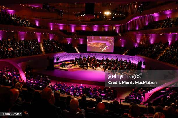 General view shows Pianist Jodi Wendt as he performs during a ceremony in Hamburg's Elbphilharmonie opera house as part of the celebrations on German...