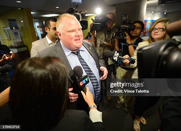 Mayor Rob Ford is surrounded by media as he leaves his office after the lunch hour at City Hall. Earlier in the day Toronto Police launched a massive...