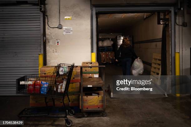 Worker loads plastic bags and wraps from a recycling collection bin into a trailer at an ACME Markets grocery store and pharmacy in Thorndale,...