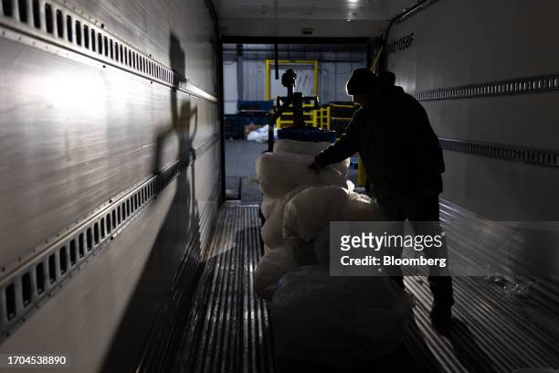 Worker sorts recyclable plastics from a trailer at an ACME and Safeway Distribution Center in Denver, Pennsylvania, US, on Tuesday, June 20, 2023....