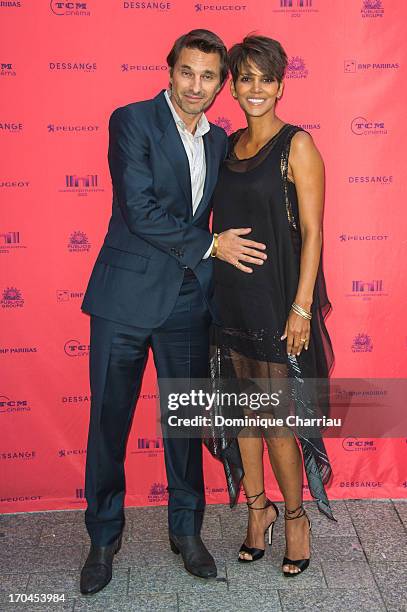 Halle Berry and Olivier Martinez attend the 'Toiles Enchantees' Red Carpet as part of the Champs Elysees Film Festival 2013 at Publicis Champs...