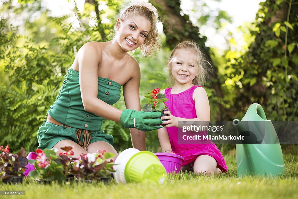 Mother and daughter planting flowers together