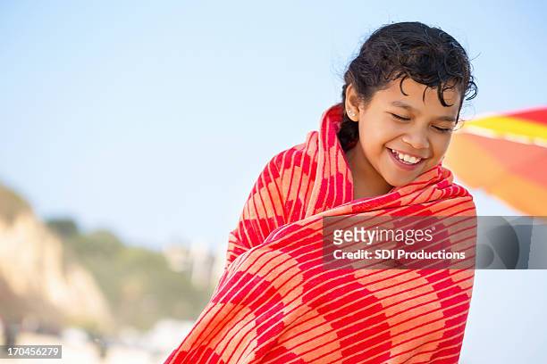 cute little girl  wrapped in towel on beach - beach towel stockfoto's en -beelden