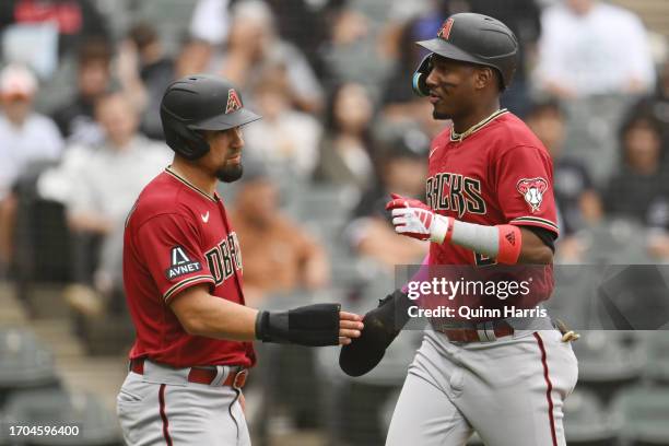 Jace Peterson and Geraldo Perdomo of the Arizona Diamondbacks celebrate after scoring in the third inning against the Chicago White Sox at Guaranteed...